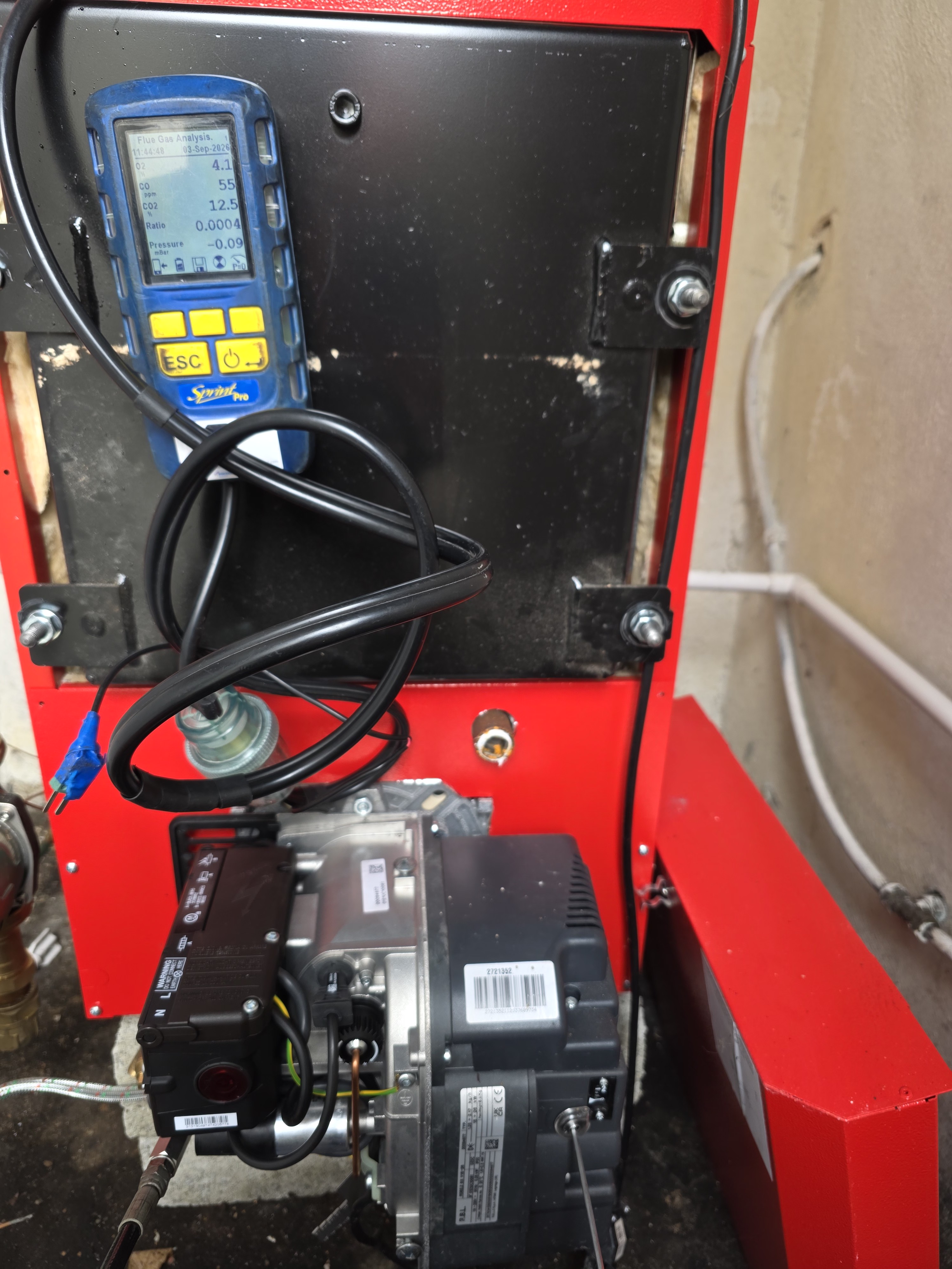 Flue gas analyser testing an oil boiler during a service and safety check